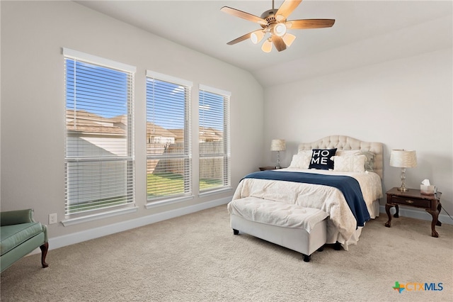 bedroom featuring ceiling fan, lofted ceiling, light carpet, and multiple windows