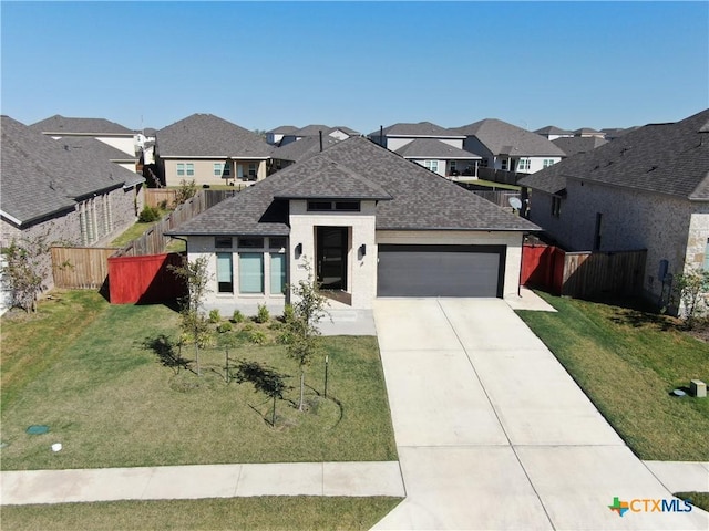 view of front facade with a front yard and a garage