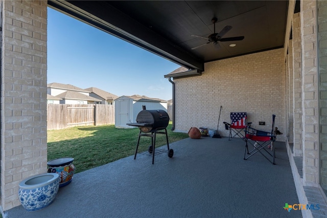 view of patio / terrace featuring a shed, ceiling fan, and a grill