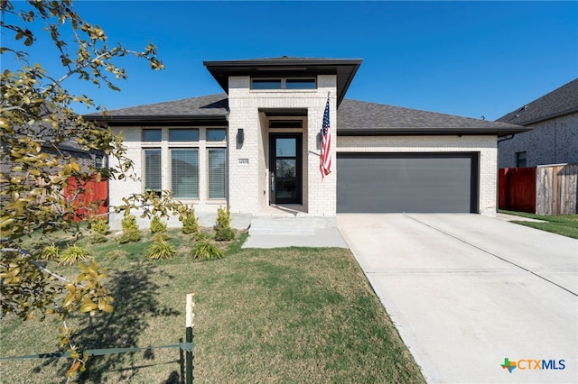 prairie-style house with a front yard and a garage