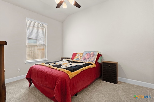 bedroom featuring ceiling fan, light colored carpet, and vaulted ceiling