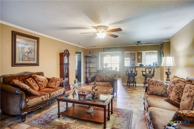 tiled living room featuring ornamental molding, a textured ceiling, and ceiling fan