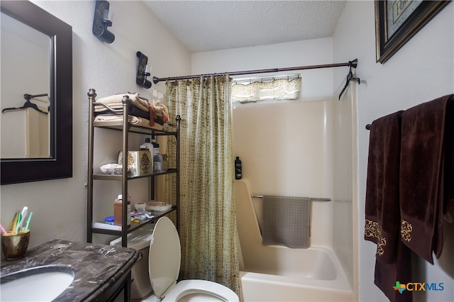 full bathroom featuring toilet, vanity, shower / bath combination with curtain, and a textured ceiling