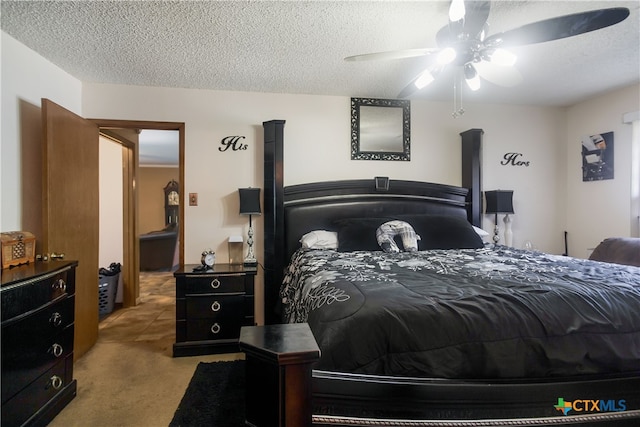 bedroom featuring ceiling fan, a textured ceiling, and light carpet