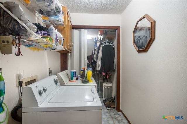 laundry room featuring a textured ceiling and washer and clothes dryer