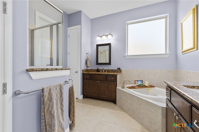 full bath featuring a bath, vanity, tile patterned flooring, and a stall shower