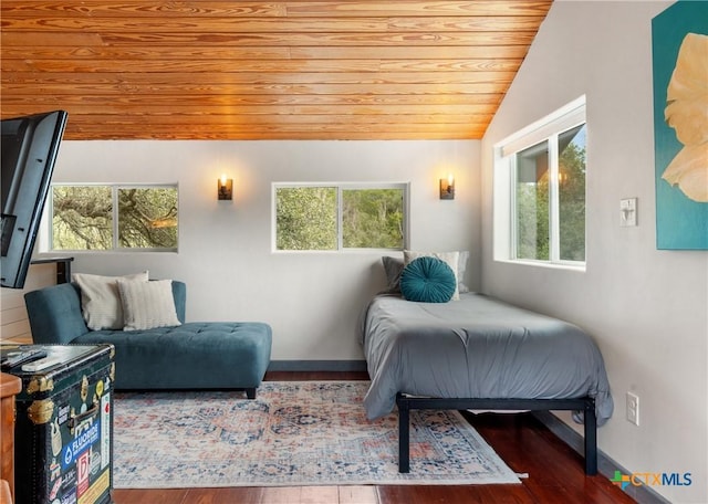 bedroom with lofted ceiling, wooden ceiling, baseboards, and wood finished floors