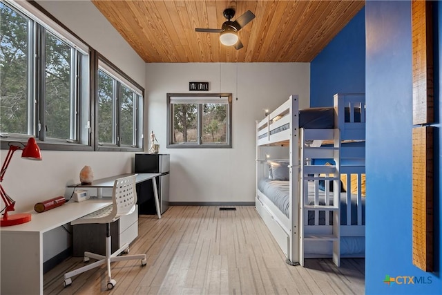 interior space with baseboards, wooden ceiling, hardwood / wood-style flooring, and a ceiling fan