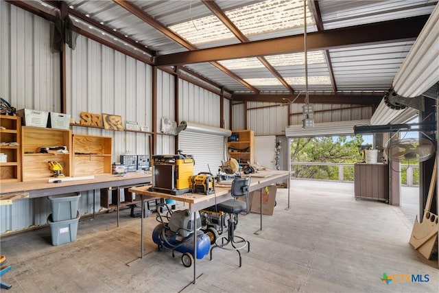 garage with a workshop area and metal wall