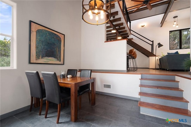 dining room with stairway, visible vents, and baseboards