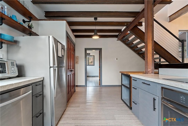 kitchen with open shelves, stainless steel appliances, beamed ceiling, and gray cabinetry