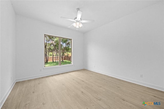 empty room with light wood-style flooring, baseboards, and ceiling fan