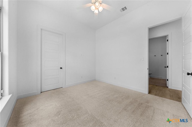 unfurnished bedroom with carpet floors, baseboards, and visible vents