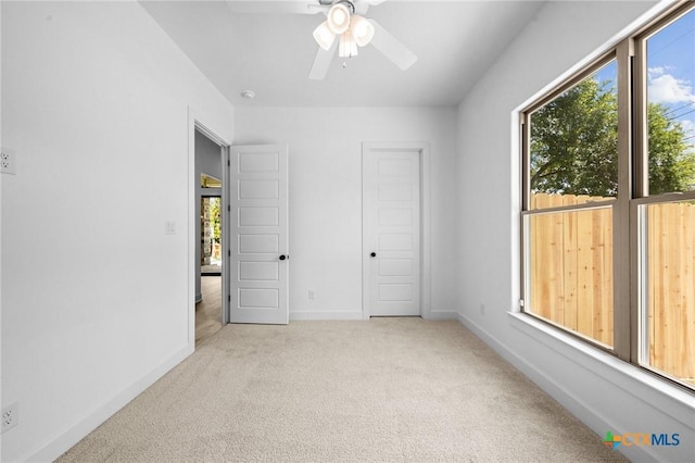 unfurnished bedroom with a ceiling fan, baseboards, and carpet flooring