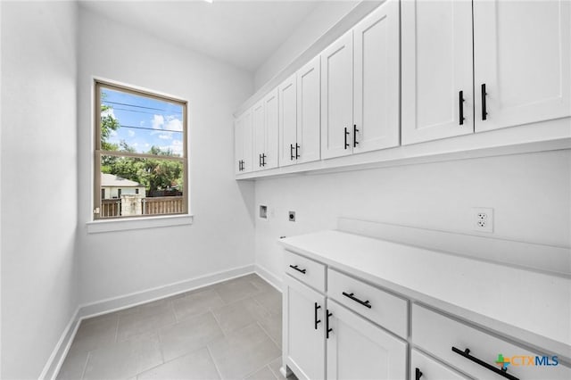 washroom featuring washer hookup, cabinet space, baseboards, and hookup for an electric dryer