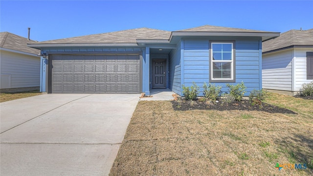 ranch-style house with a garage, a front lawn, and concrete driveway