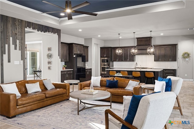 living room with ceiling fan and sink