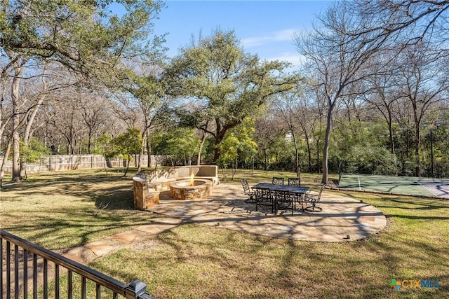 view of yard featuring a fire pit and fence