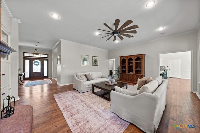 living area featuring crown molding and wood finished floors