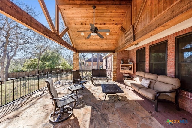 view of patio with an outdoor hangout area, fence, and a ceiling fan