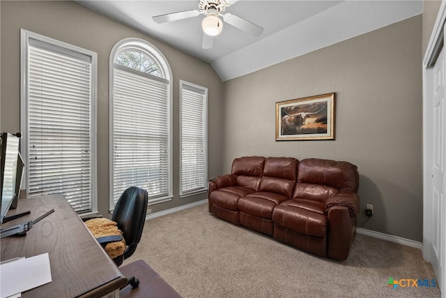 office space featuring vaulted ceiling, ceiling fan, carpet, and baseboards