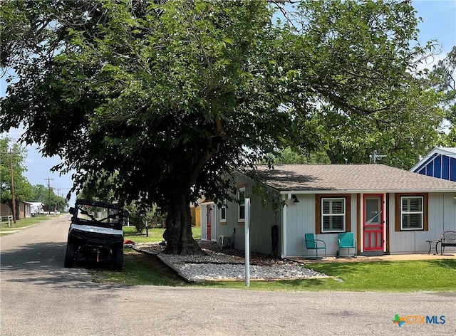 201 Sycamore, Tow, TX 78672 - view of front of property featuring roof with shingles and a front lawn
