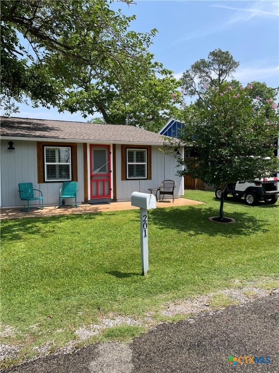 201 Sycamore, Tow, TX 78672 - single story home featuring a front lawn and board and batten siding