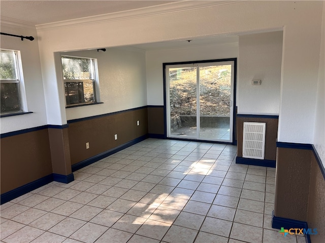 tiled spare room with crown molding