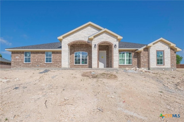 3006 Whitetail Trl, Nolanville, TX 76559 - view of front of house featuring brick siding, a shingled roof, and stone siding