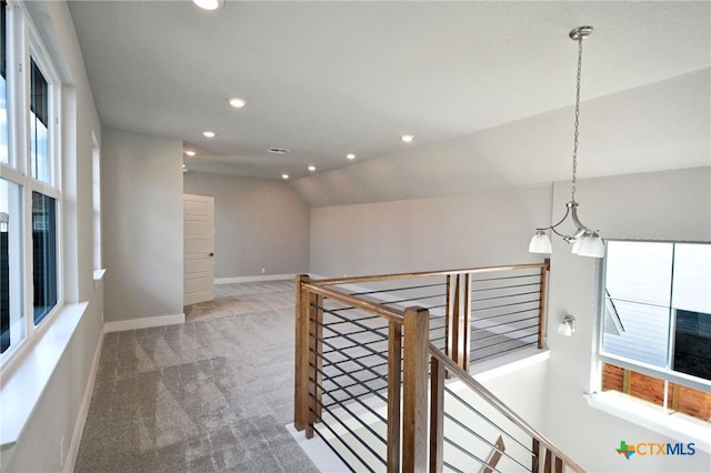 corridor featuring baseboards, carpet floors, lofted ceiling, recessed lighting, and an upstairs landing