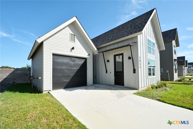 view of front of house with a garage and a front lawn