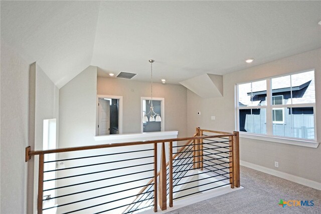 interior space featuring carpet, visible vents, baseboards, recessed lighting, and an upstairs landing