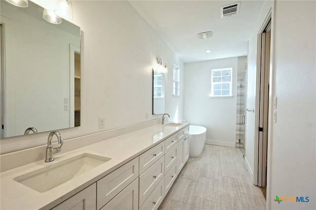 bathroom featuring independent shower and bath and vanity