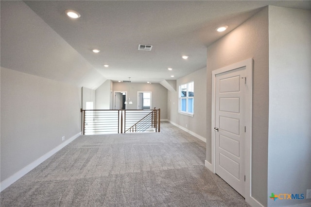 additional living space featuring lofted ceiling, carpet, visible vents, and baseboards