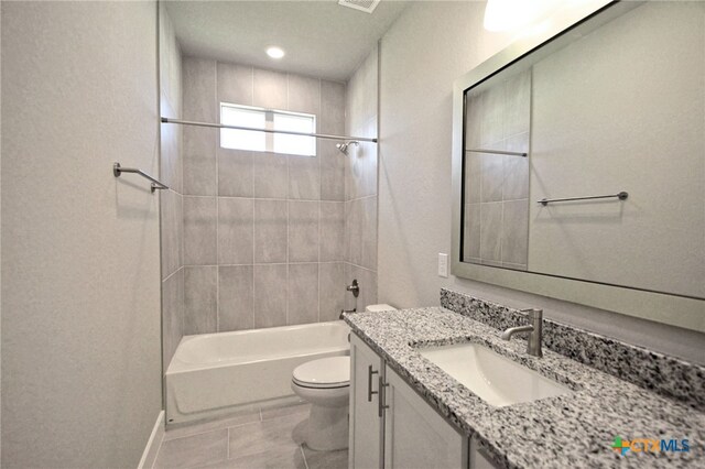 bathroom with toilet, shower / washtub combination, and vanity