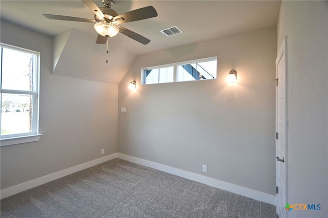 empty room with carpet flooring, baseboards, visible vents, and plenty of natural light