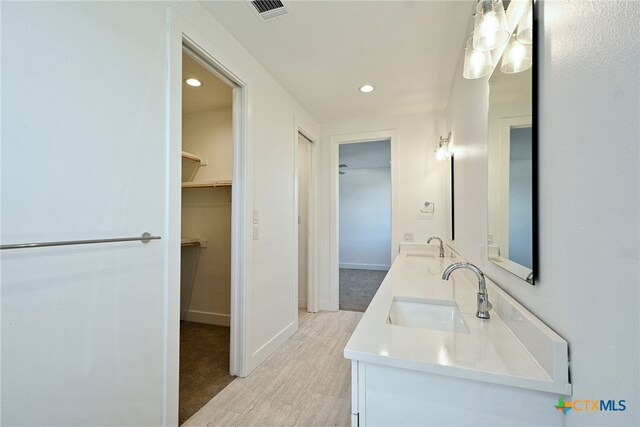 bathroom featuring hardwood / wood-style flooring and vanity