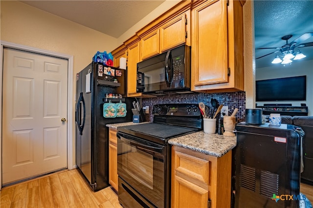 kitchen with black appliances, ceiling fan, light hardwood / wood-style floors, and backsplash