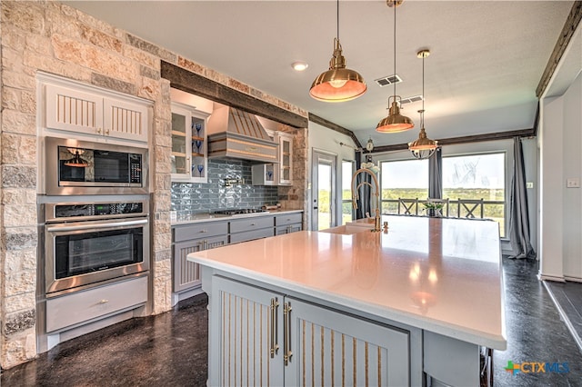 kitchen with gray cabinets, appliances with stainless steel finishes, a large island, and hanging light fixtures