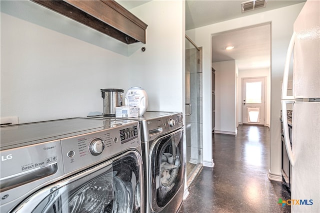 clothes washing area with washer and dryer