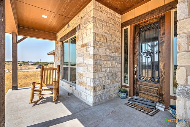 doorway to property with a porch