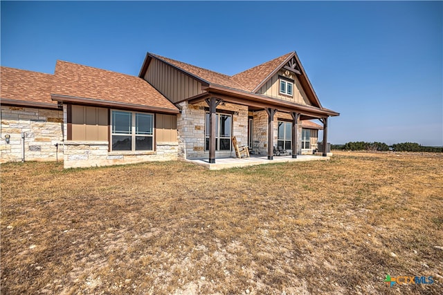 rear view of property with a patio and a yard