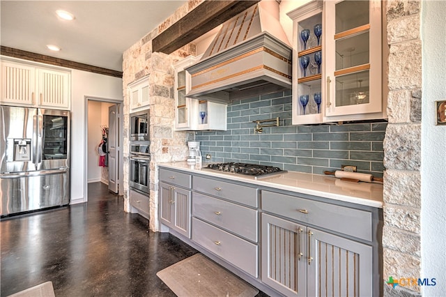 kitchen with custom exhaust hood, stainless steel appliances, backsplash, and gray cabinetry