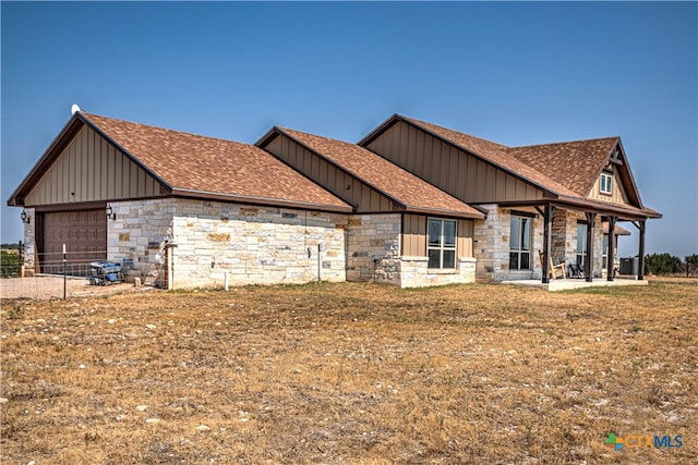 craftsman house with a garage and a front yard