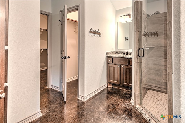 bathroom with vanity and a shower with door