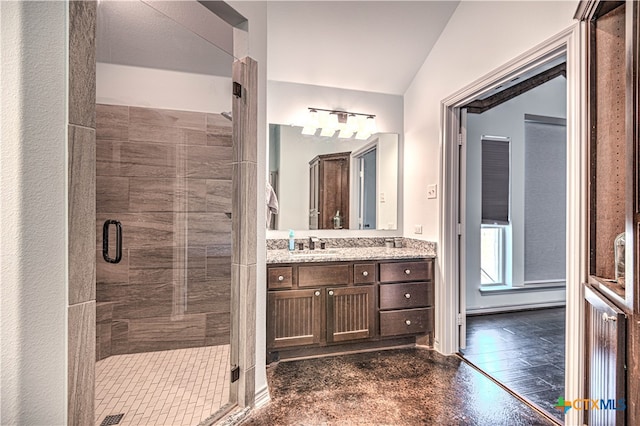 bathroom featuring vanity, an enclosed shower, and lofted ceiling