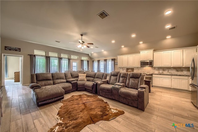 living area with light wood-style floors, a ceiling fan, recessed lighting, and visible vents