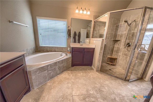 full bathroom featuring vanity, a stall shower, and a bath