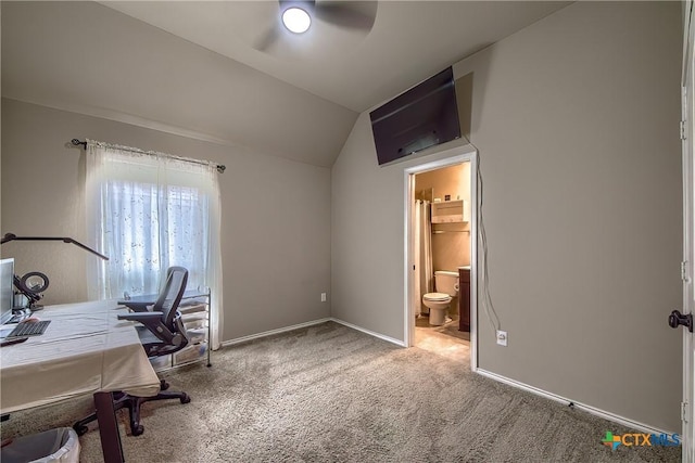 carpeted office featuring baseboards, ceiling fan, and vaulted ceiling