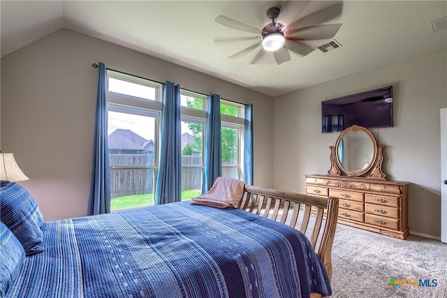 bedroom with visible vents, ceiling fan, lofted ceiling, and carpet